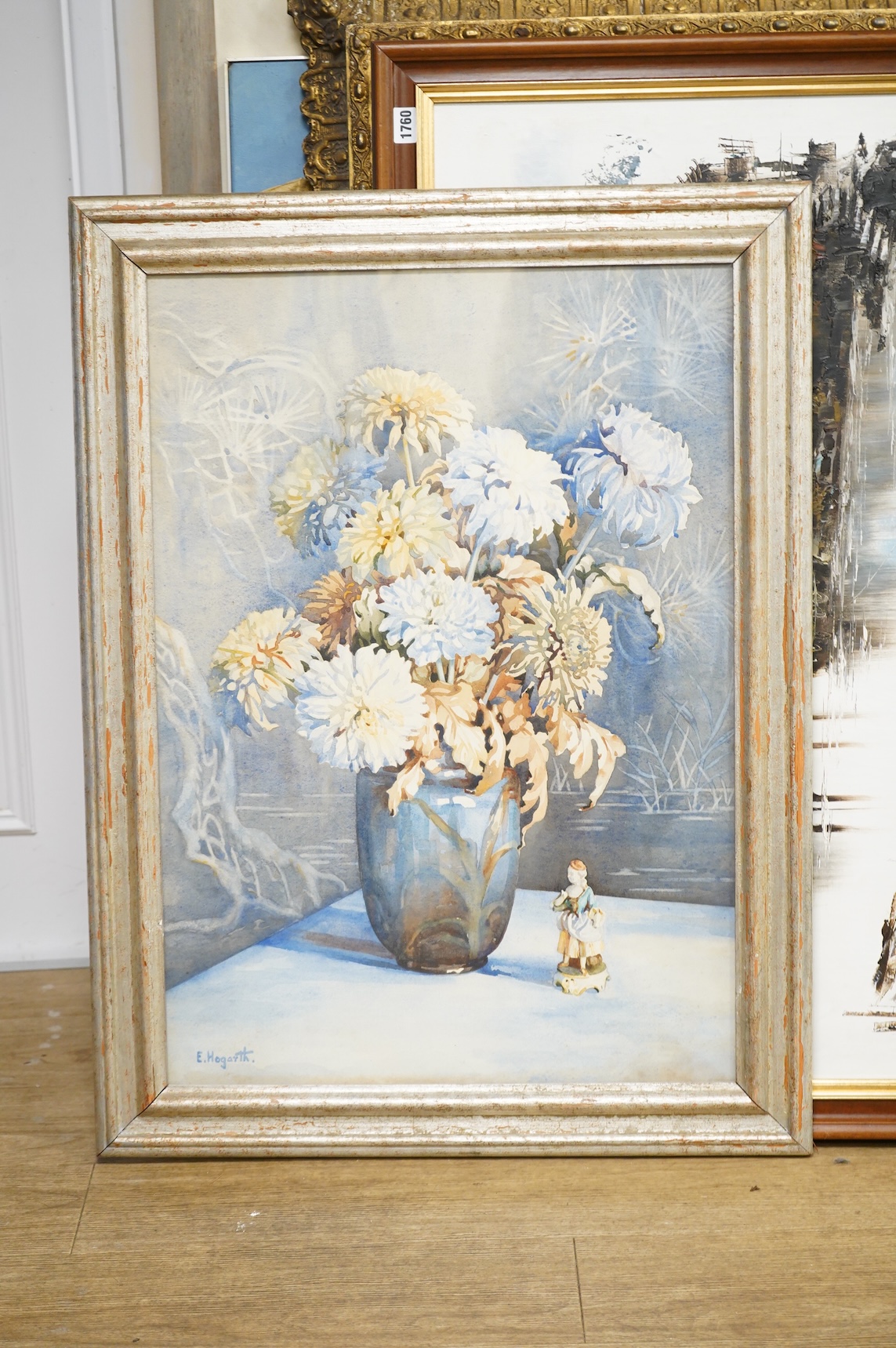 E. Hogarth, Still life of a vase with chrysanthemums and china figures, signed, watercolour, 74 x 51cm